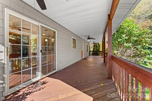 a view of balcony with wooden floor and fence