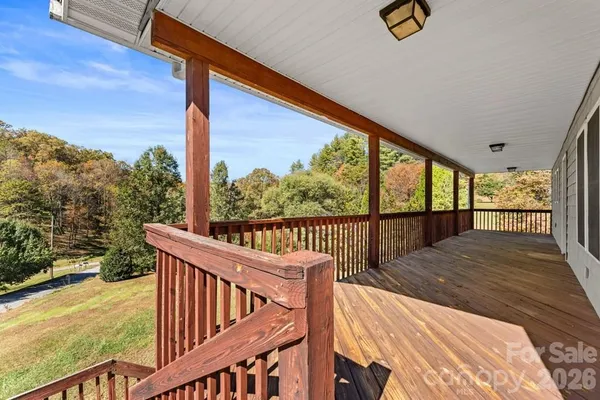 a view of balcony with wooden floor and fence