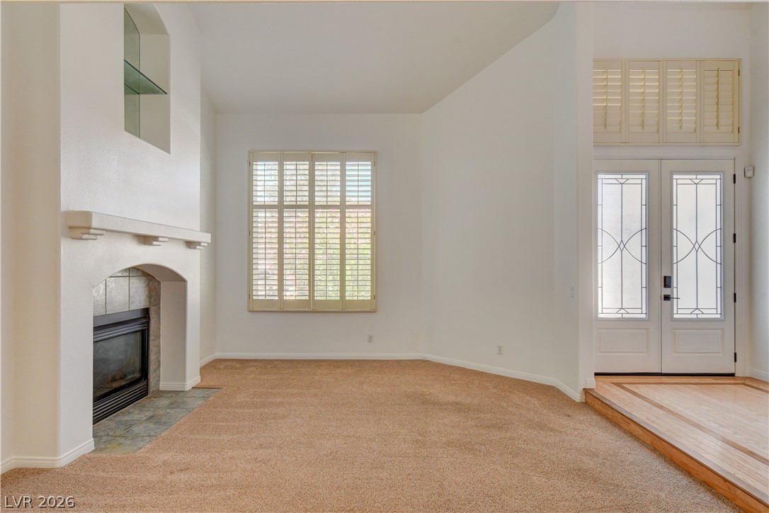 4354 Tall Tree Street Las Vegas, NV 89147 - Photo 13 of 67 This inviting space features a cozy fireplace, abundant natural light, and elegant entryway.