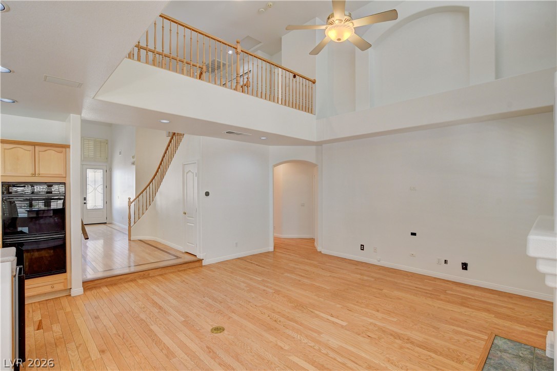 4354 Tall Tree Street Las Vegas, NV 89147 - Photo 67 of 67 This expansive interior features an open floorplan with high ceilings and rich hardwood flooring.