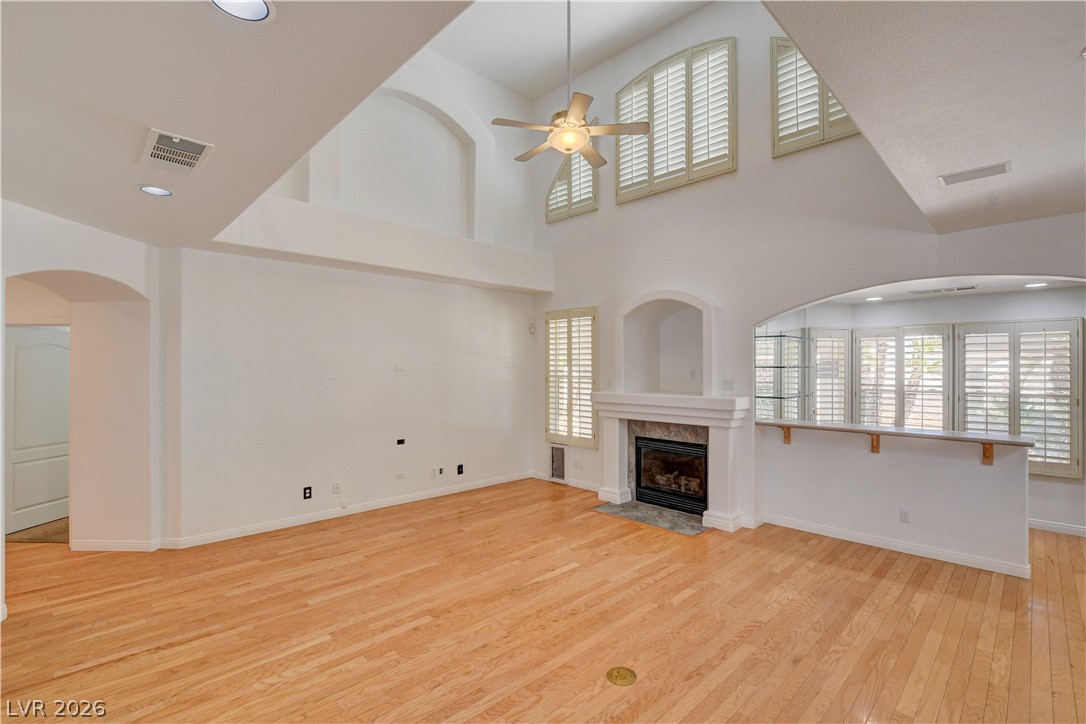 4354 Tall Tree Street Las Vegas, NV 89147 - Photo 16 of 67 This airy living space features soaring ceilings, hardwood floors, and a charming fireplace for cozy gatherings.