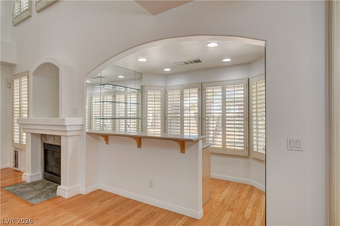 4354 Tall Tree Street Las Vegas, NV 89147 - Photo 18 of 67 Entertain guests in this bright living space with a wet bar, fireplace, and hardwood flooring.