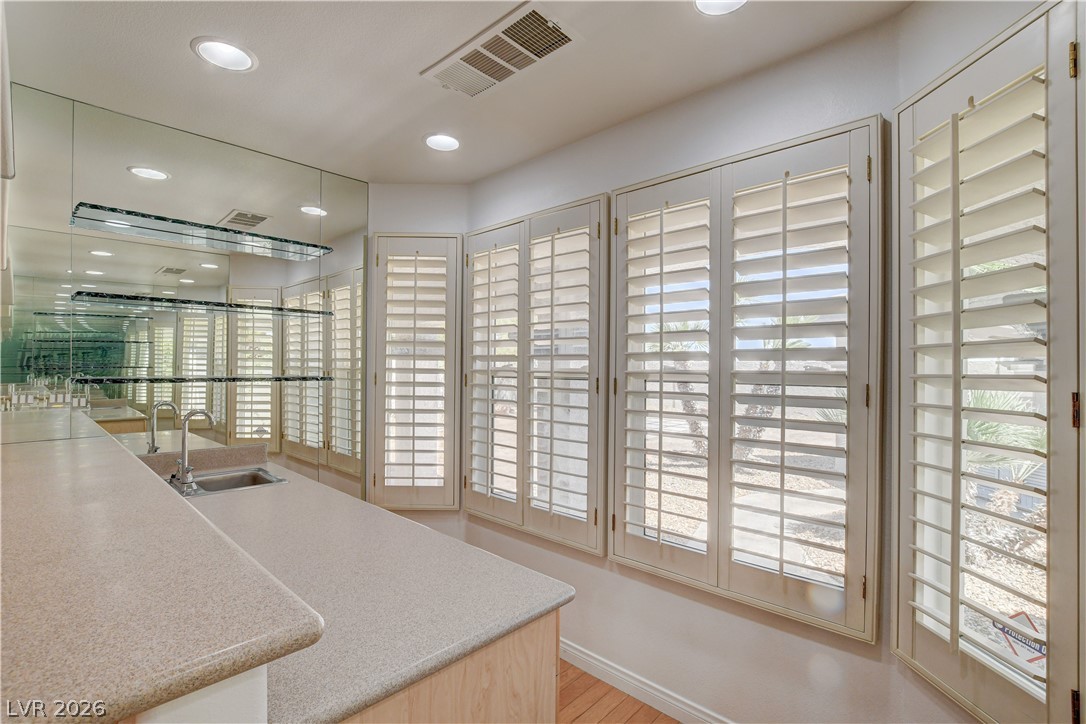 4354 Tall Tree Street Las Vegas, NV 89147 - Photo 19 of 67 This inviting space features a wet bar with mirrored accents, perfect for entertaining guests.