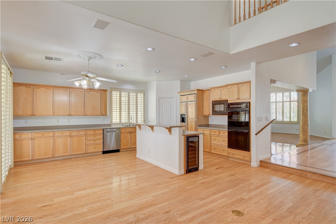 4354 Tall Tree Street Las Vegas, NV 89147 - Photo 20 of 67 This expansive kitchen features light wood cabinetry, providing abundant storage and a warm, inviting atmosphere.