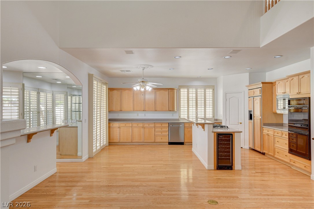 4354 Tall Tree Street Las Vegas, NV 89147 - Photo 22 of 67 This expansive kitchen features warm wood cabinetry, gleaming hardwood floors, and ample natural light.