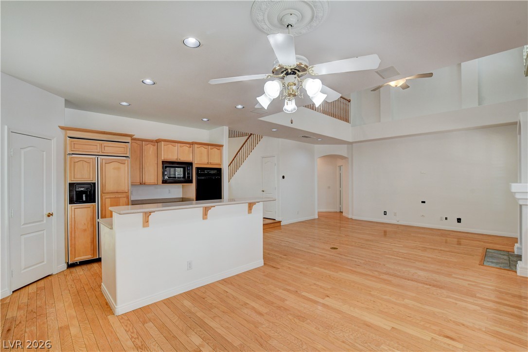 4354 Tall Tree Street Las Vegas, NV 89147 - Photo 26 of 67 This expansive open concept space features gleaming hardwood floors and high ceilings, ideal for modern living.