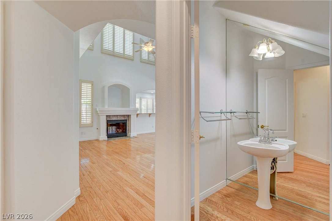 4354 Tall Tree Street Las Vegas, NV 89147 - Photo 27 of 67 This living space features hardwood flooring and a fireplace, creating a warm and inviting atmosphere.