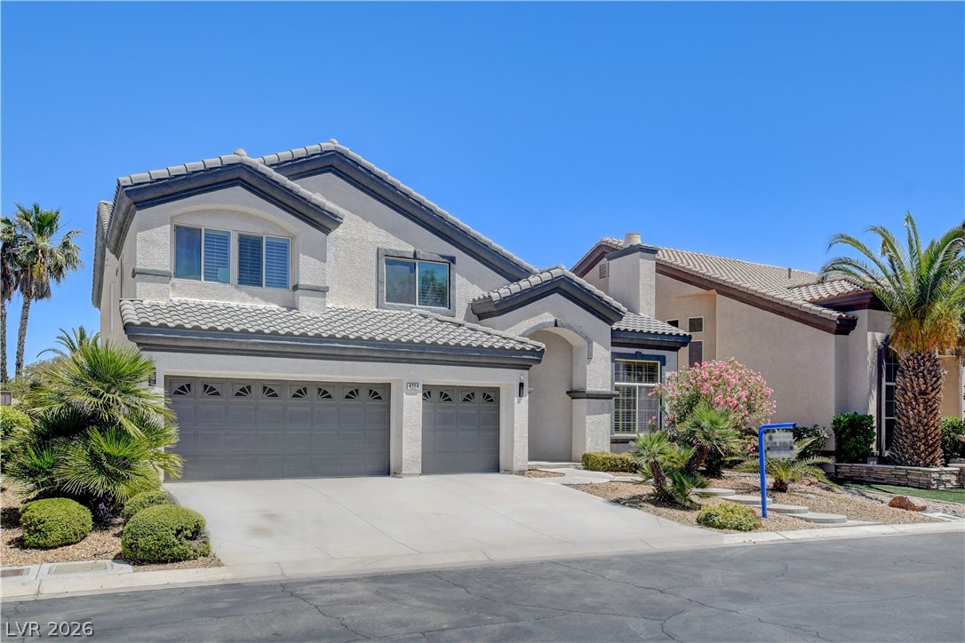 4354 Tall Tree Street Las Vegas, NV 89147 - Photo 3 of 67 This residence features a stucco exterior and an inviting entryway with a tile roof and attached garage.