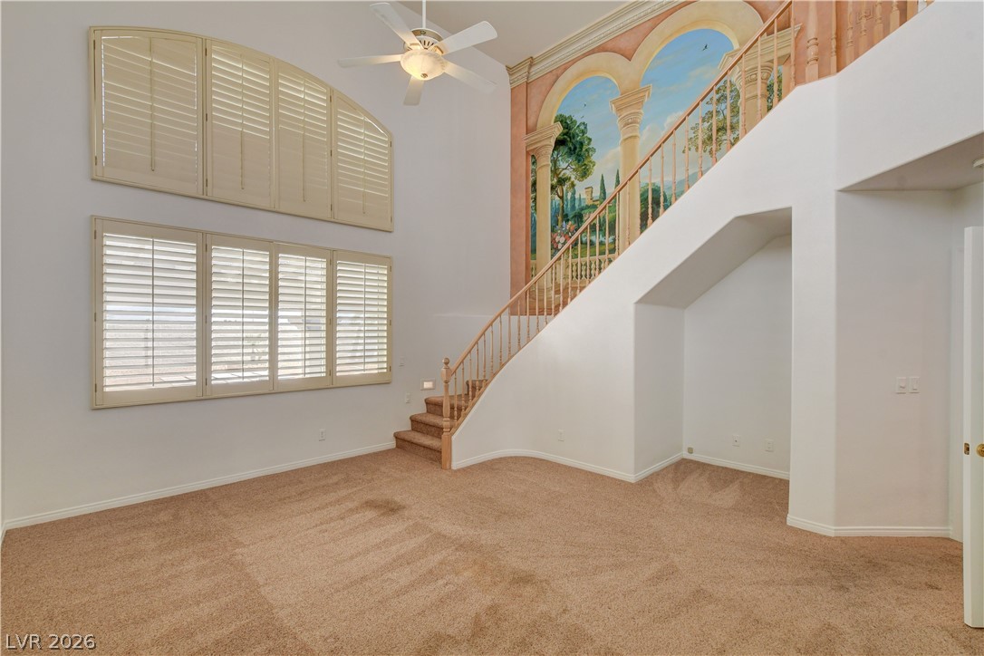 4354 Tall Tree Street Las Vegas, NV 89147 - Photo 30 of 67 Step into this spacious living area featuring a grand staircase and abundant natural light.