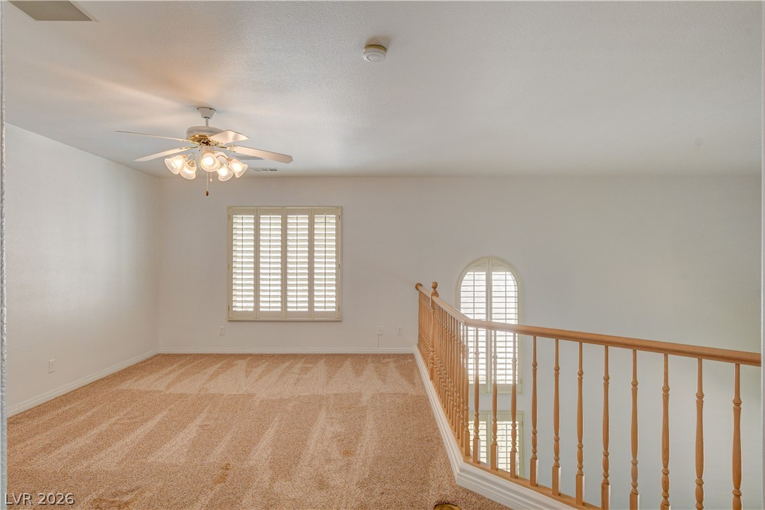 4354 Tall Tree Street Las Vegas, NV 89147 - Photo 33 of 67 This airy space features carpet flooring, providing comfort and style to this inviting room.