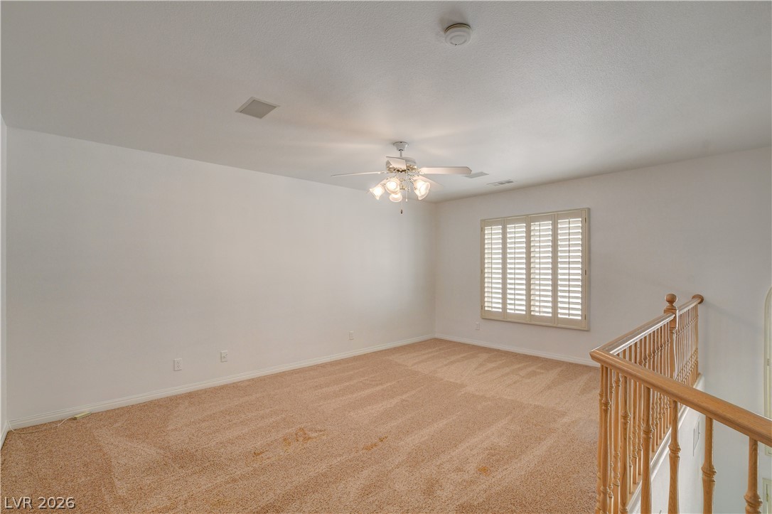 4354 Tall Tree Street Las Vegas, NV 89147 - Photo 34 of 67 This versatile loft area offers abundant natural light and soft carpeting, perfect for flexible living.