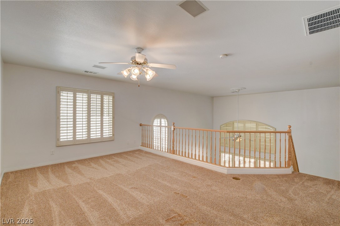 4354 Tall Tree Street Las Vegas, NV 89147 - Photo 35 of 67 This versatile loft area features ample natural light and a charming railing overlooking the space below.