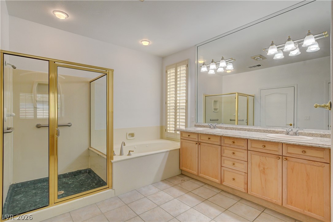 4354 Tall Tree Street Las Vegas, NV 89147 - Photo 37 of 67 This spacious bathroom offers dual vanities, a soaking tub, and a shower with glass enclosure.