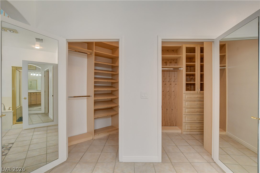 4354 Tall Tree Street Las Vegas, NV 89147 - Photo 38 of 67 These custom closets offer organized storage and a seamless transition to the primary bathroom.