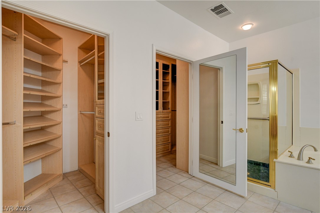4354 Tall Tree Street Las Vegas, NV 89147 - Photo 39 of 67 This spacious dressing area features custom shelving, ample storage, and easy access to the primary bathroom.