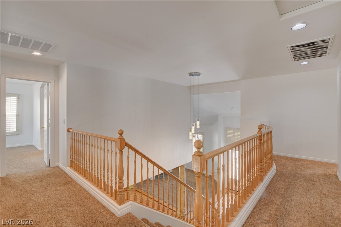 4354 Tall Tree Street Las Vegas, NV 89147 - Photo 42 of 67 This spacious landing features a stylish chandelier, offering a bright and inviting welcome to the upper level.