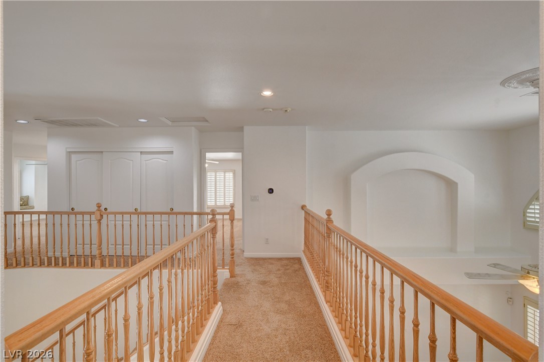 4354 Tall Tree Street Las Vegas, NV 89147 - Photo 43 of 67 This spacious landing features plush carpeting and charming wooden railings.