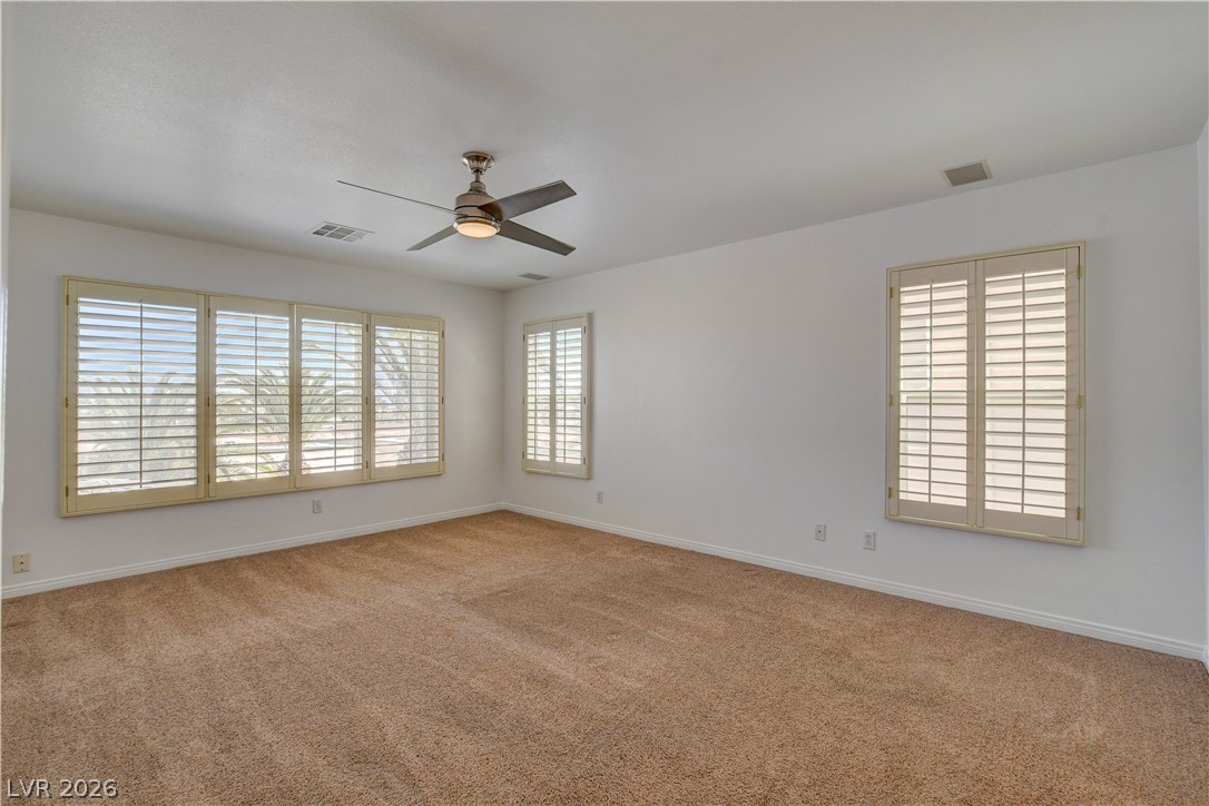 4354 Tall Tree Street Las Vegas, NV 89147 - Photo 49 of 67 Bright and airy, this room offers ample natural light and plush carpeting.