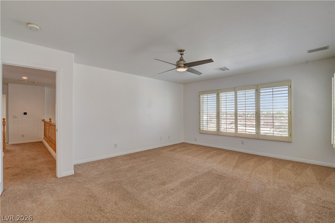 4354 Tall Tree Street Las Vegas, NV 89147 - Photo 50 of 67 This bright and airy room offers comfortable carpeting and window shutters for privacy.
