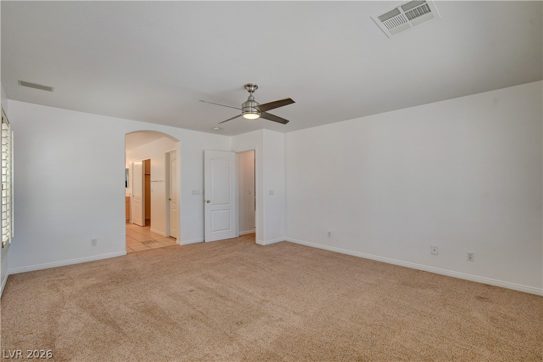 4354 Tall Tree Street Las Vegas, NV 89147 - Photo 51 of 67 This spacious bedroom offers ample comfort and an inviting ambiance for peaceful retreats.