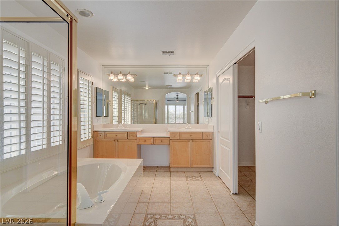 4354 Tall Tree Street Las Vegas, NV 89147 - Photo 53 of 67 This spacious bathroom offers a large soaking tub and dual vanities for ultimate comfort.