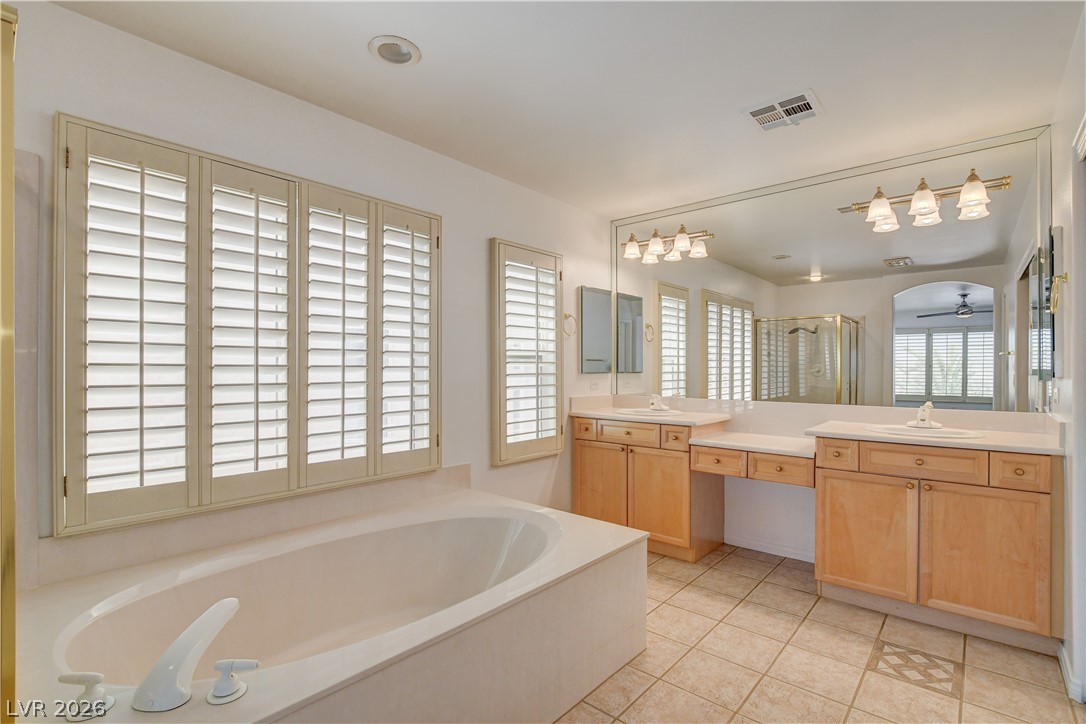 4354 Tall Tree Street Las Vegas, NV 89147 - Photo 54 of 67 This spacious bathroom offers a relaxing soaking tub and dual vanities for ultimate comfort.