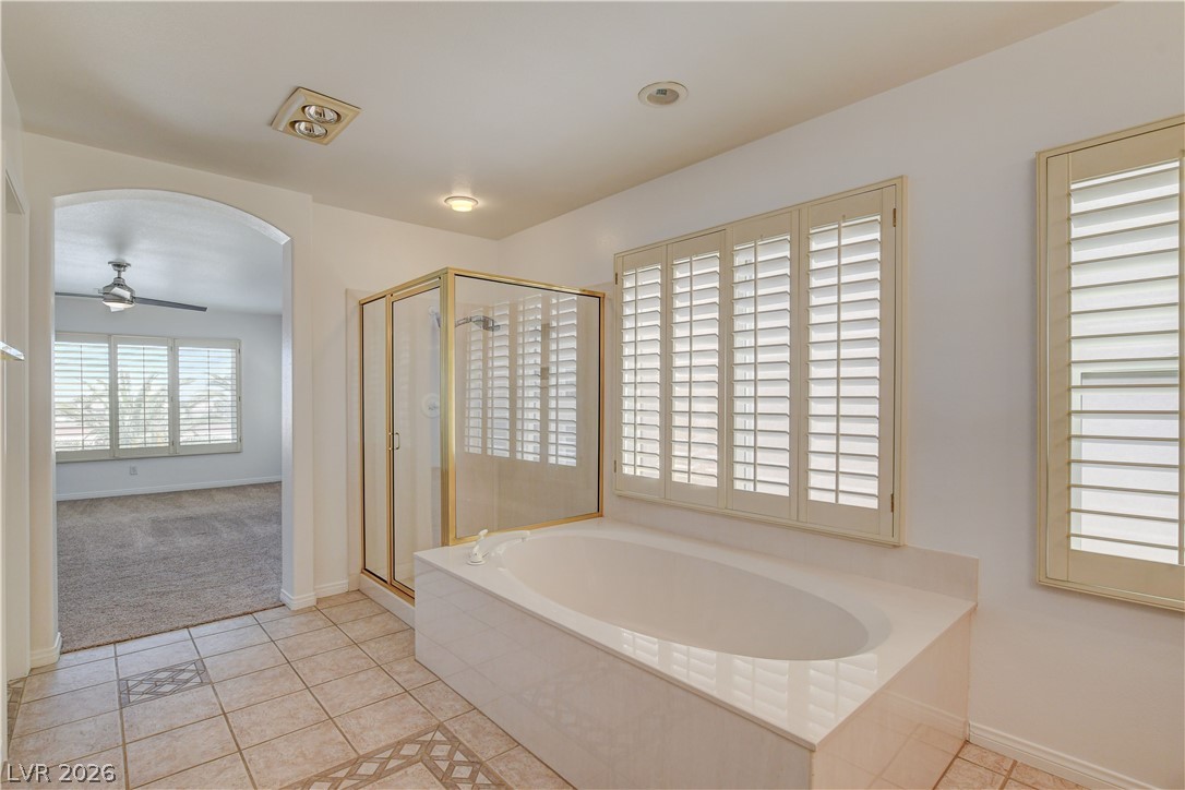 4354 Tall Tree Street Las Vegas, NV 89147 - Photo 55 of 67 This primary bathroom offers a shower and a soaking tub with abundant natural light.
