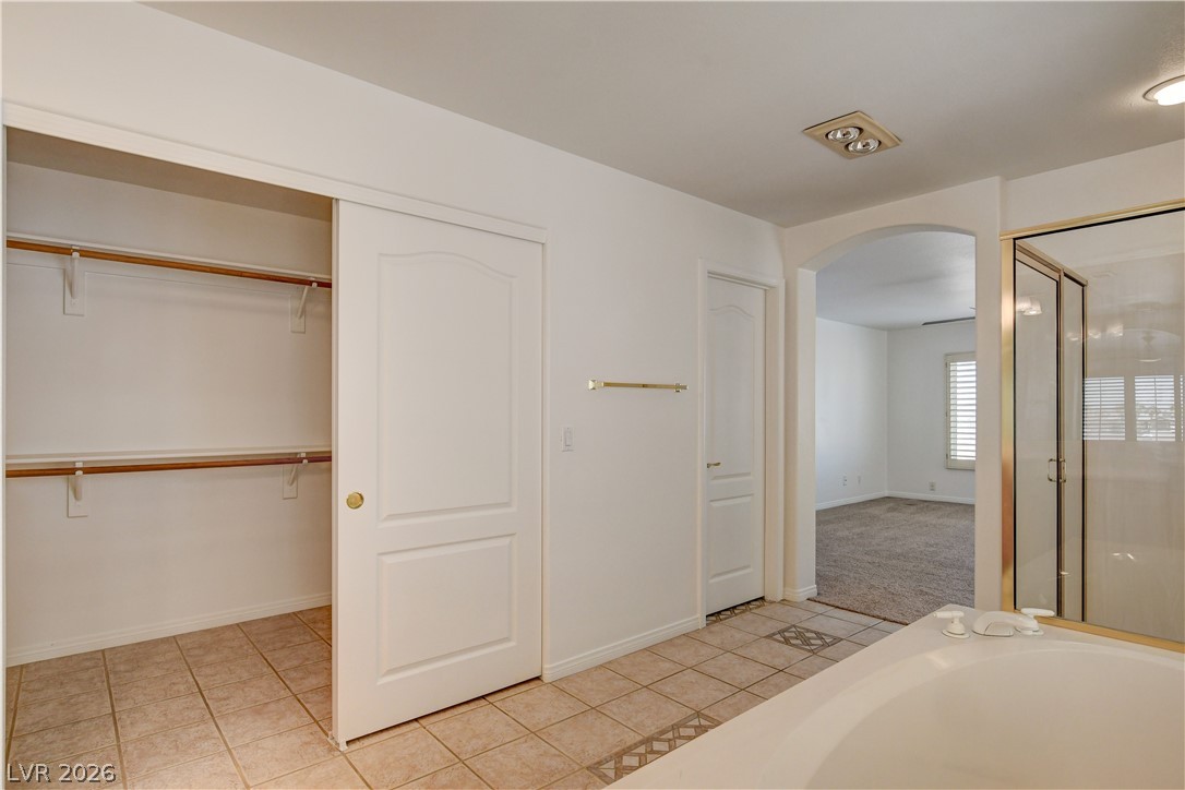 4354 Tall Tree Street Las Vegas, NV 89147 - Photo 56 of 67 This primary bathroom features a shower, a soaking tub, and an expansive walk-in closet.