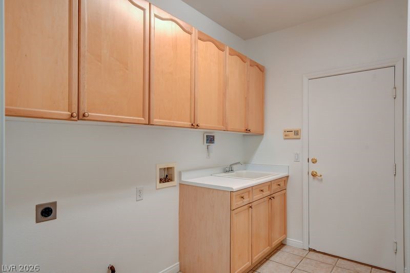 4354 Tall Tree Street Las Vegas, NV 89147 - Photo 57 of 67 This functional laundry room features ample storage and a convenient utility sink.