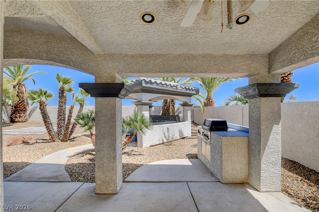4354 Tall Tree Street Las Vegas, NV 89147 - Photo 59 of 67 This spacious covered patio offers an outdoor kitchen perfect for al fresco dining and entertaining.