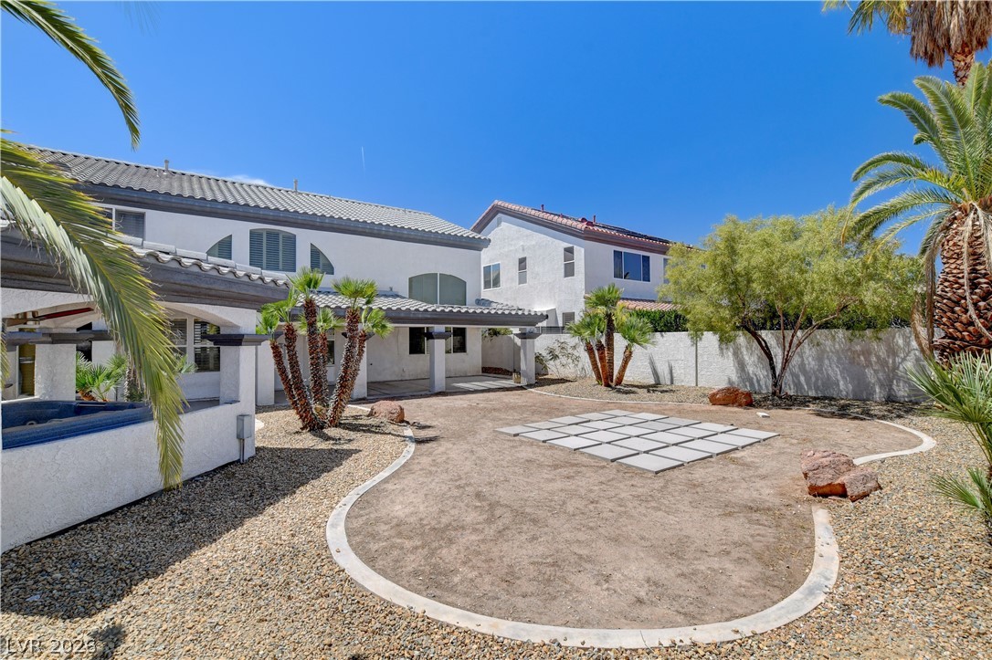 4354 Tall Tree Street Las Vegas, NV 89147 - Photo 64 of 67 This spacious backyard awaits your personal touch, featuring a covered patio perfect for outdoor entertaining.