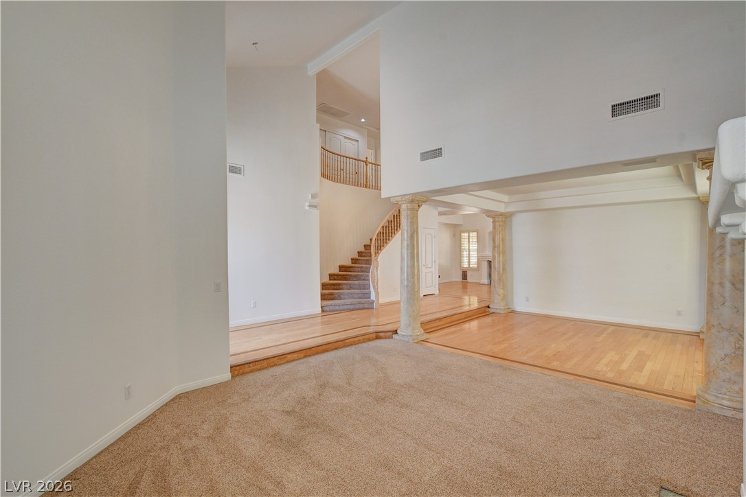 4354 Tall Tree Street Las Vegas, NV 89147 - Photo 8 of 67 This grand foyer showcases a sweeping staircase and elegant architectural columns, inviting entry into a gracious home.