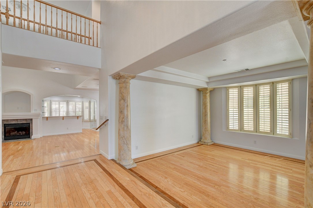 4354 Tall Tree Street Las Vegas, NV 89147 - Photo 10 of 67 This airy interior boasts beautiful hardwood flooring and a cozy fireplace, perfect for elegant living.