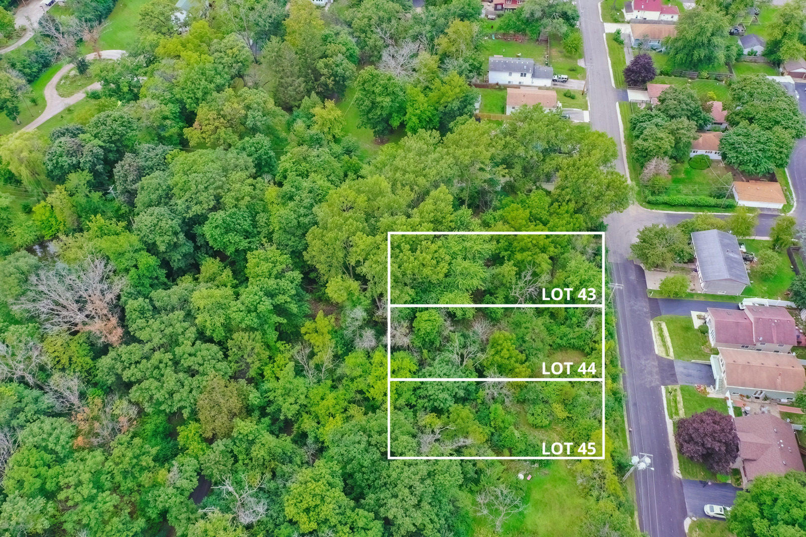 2 Lake Avenue Round Lake Beach, IL 60073 - Photo 1 of 10 an aerial view of a residential apartment building with a yard and plants