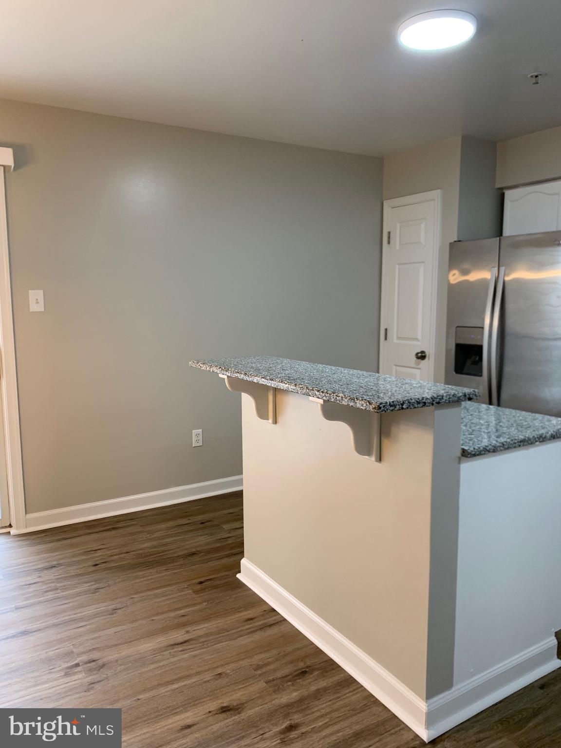 114 Sentry Ridge Smithsburg, MD 21783 - Photo 10 of 60 a view of a refrigerator in kitchen and wooden floor