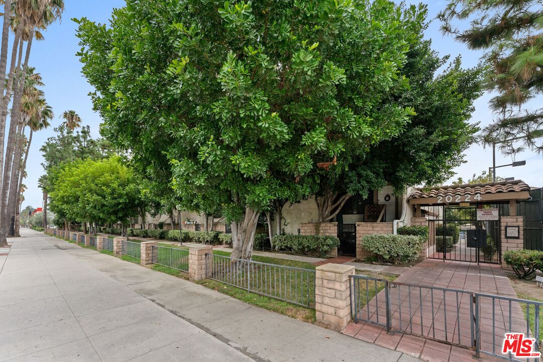 an outdoor view of house with sign board and yard