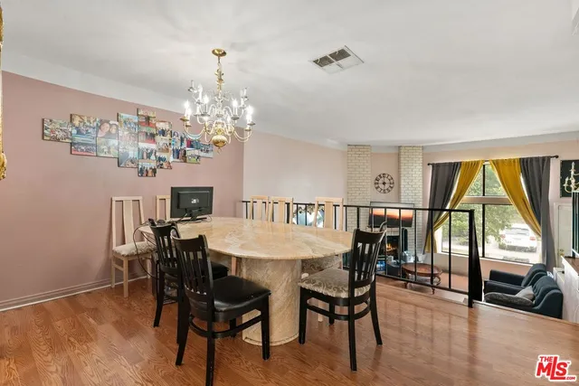 a view of a dining room with furniture and a chandelier