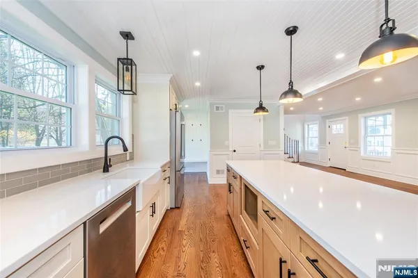 a kitchen with a stove a sink and a window