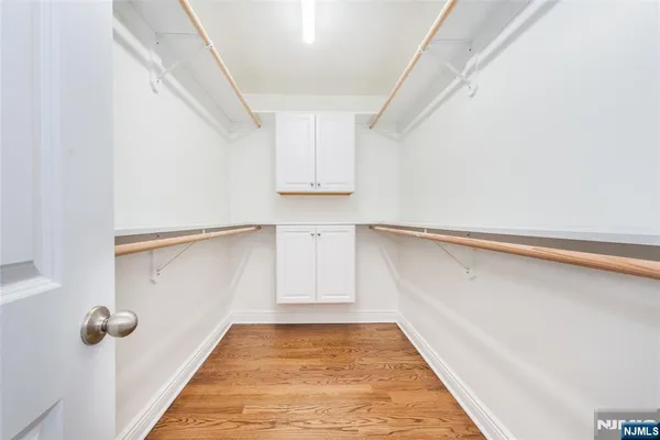 a view of a room with wooden floor and cabinet