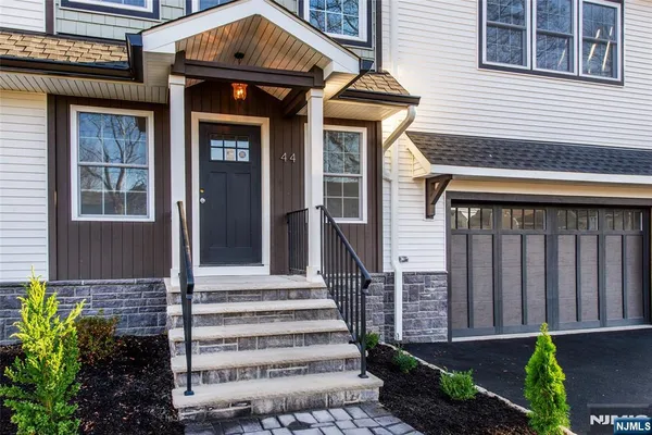 a front view of a house with a garden