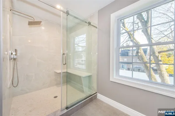 a bathroom with a shower and a bath tub