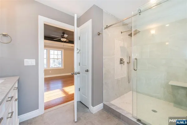 a bathroom with a granite countertop toilet sink and mirror