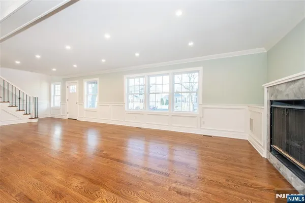 a large kitchen with cabinets wooden floor and stainless steel appliances