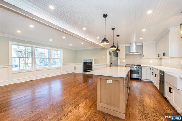 a kitchen with granite countertop a sink stove and cabinets