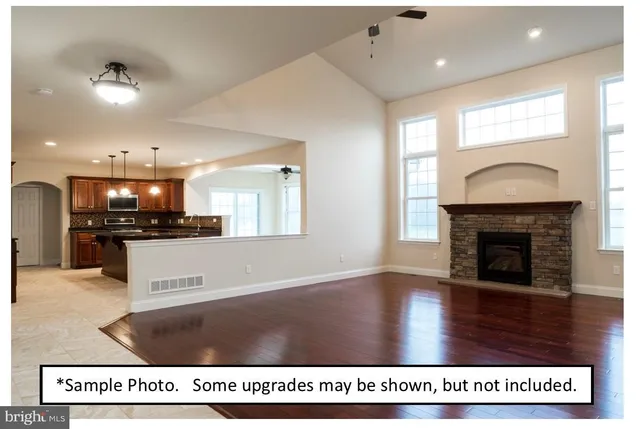 a view of kitchen with kitchen island a sink counter top and a fireplace
