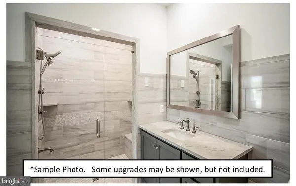 a bathroom with a tub a sink and mirror