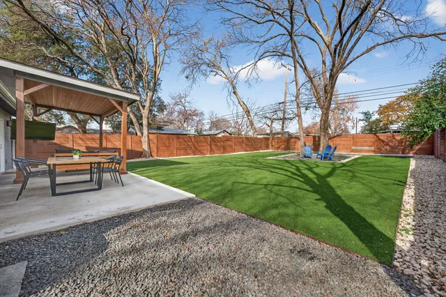 a park view with a bench and trees
