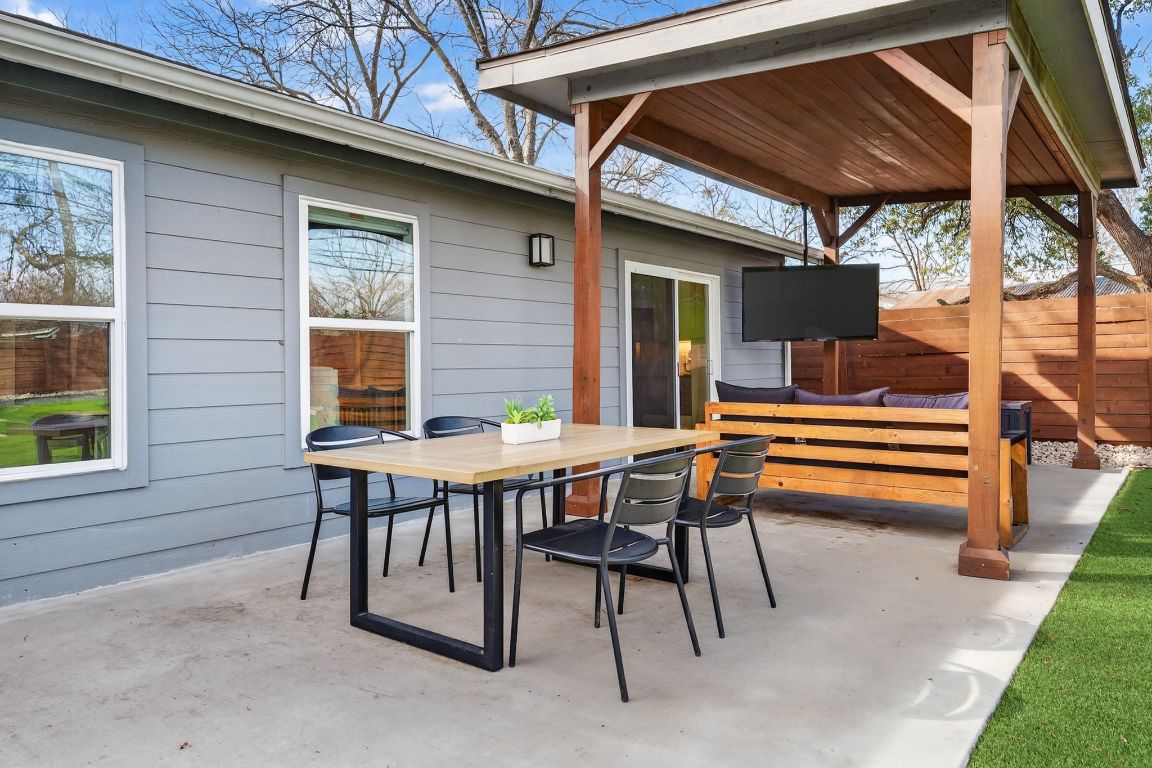 504 West Croslin Street Austin, TX 78752 - Photo 19 of 22 a backyard of a house with barbeque oven table and chairs