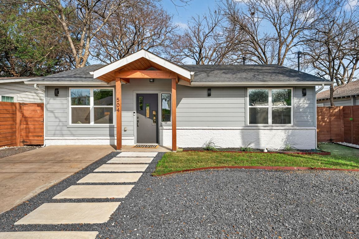 504 West Croslin Street Austin, TX 78752 - Photo 21 of 22 a front view of a house with a yard and garage