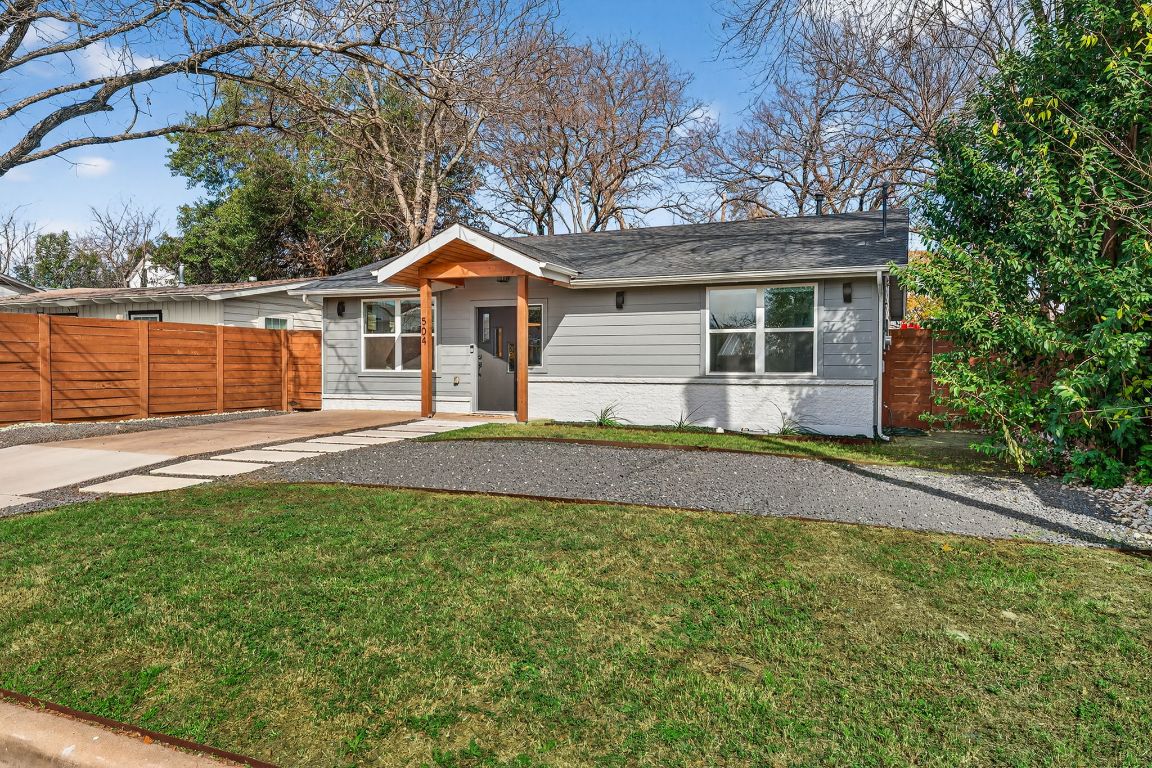504 West Croslin Street Austin, TX 78752 - Photo 22 of 22 a front view of a house with a yard and trees